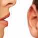 Close-up of a woman speaking into man's ear