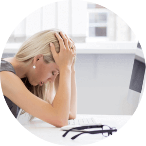Woman feeling stressed at her desk.