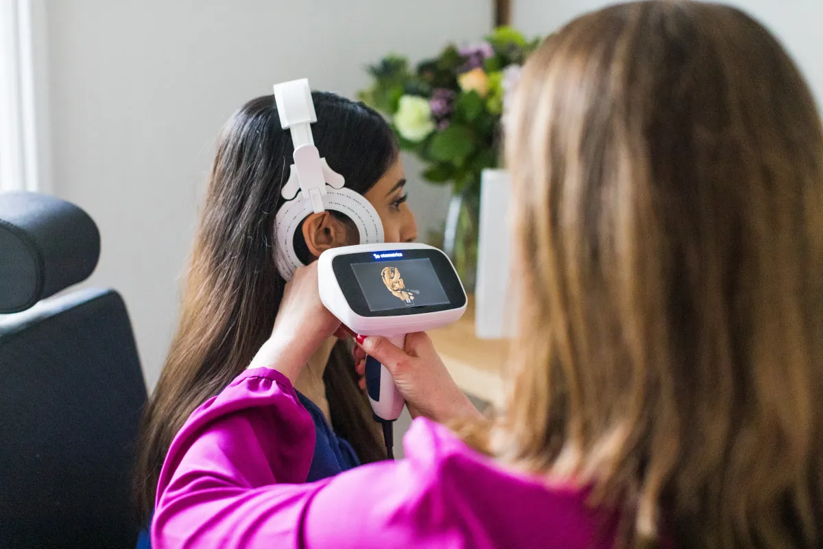 hand held screen showing examined ear