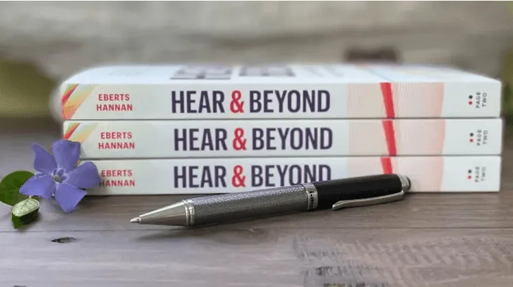Books and pen on table.