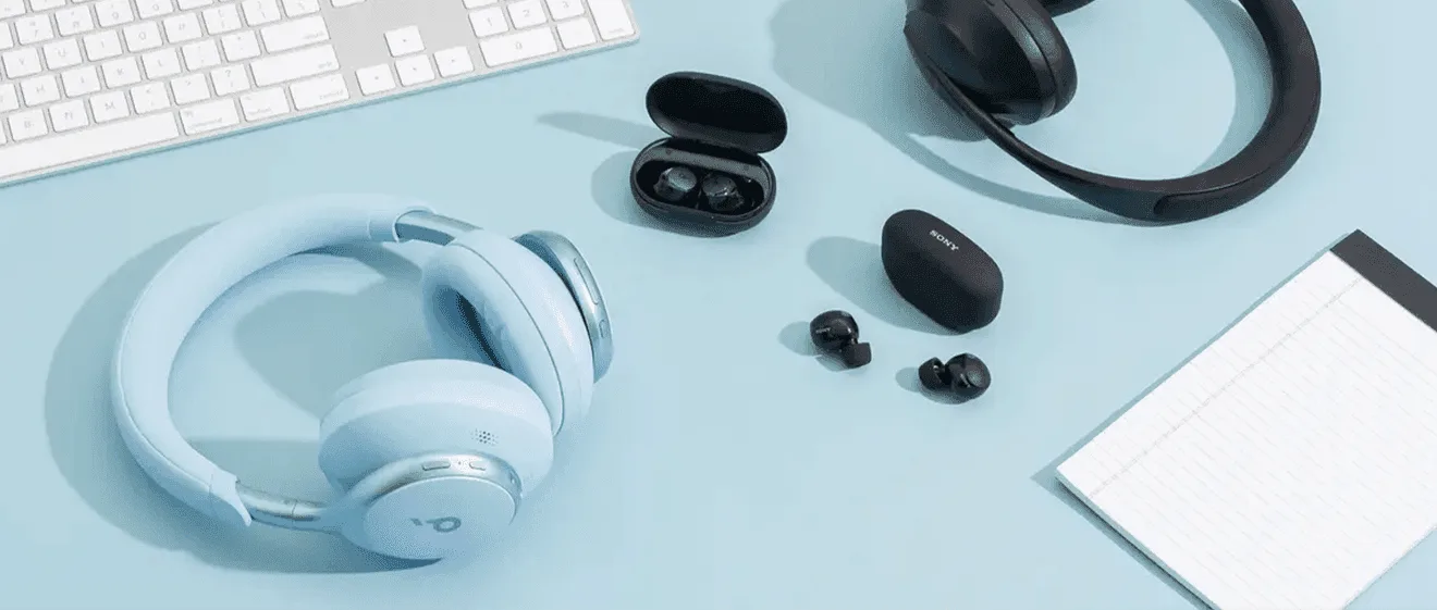 Headphones and earbuds on desk.