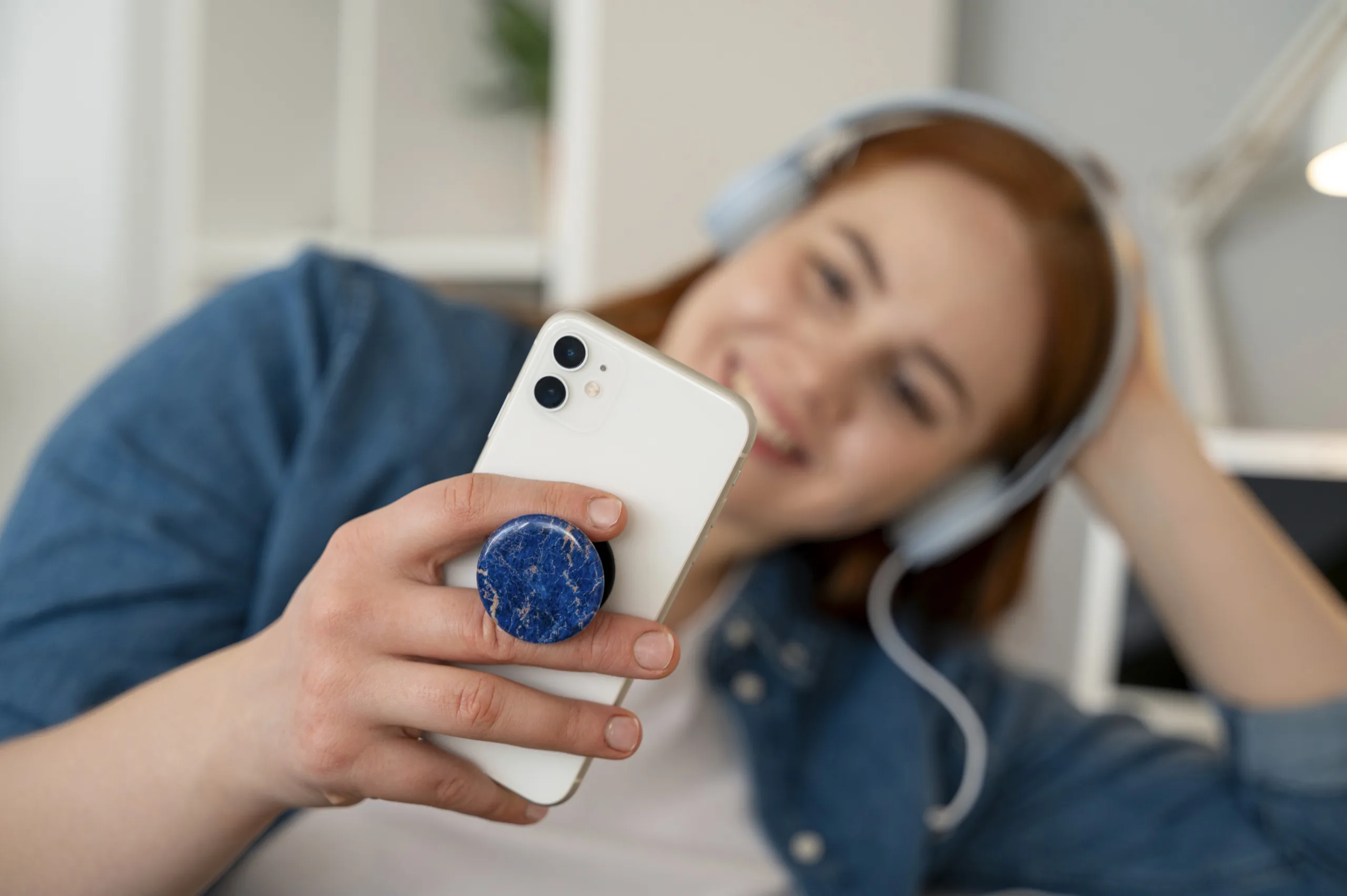 Person smiling with smartphone.