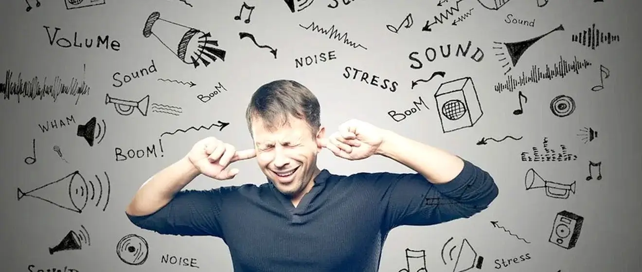 Man covering ears, surrounded by noise.