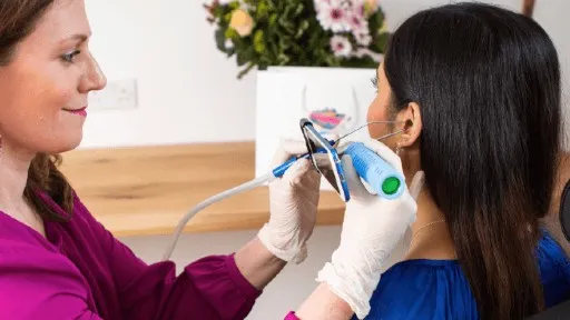 Ear examination with otoscope.
