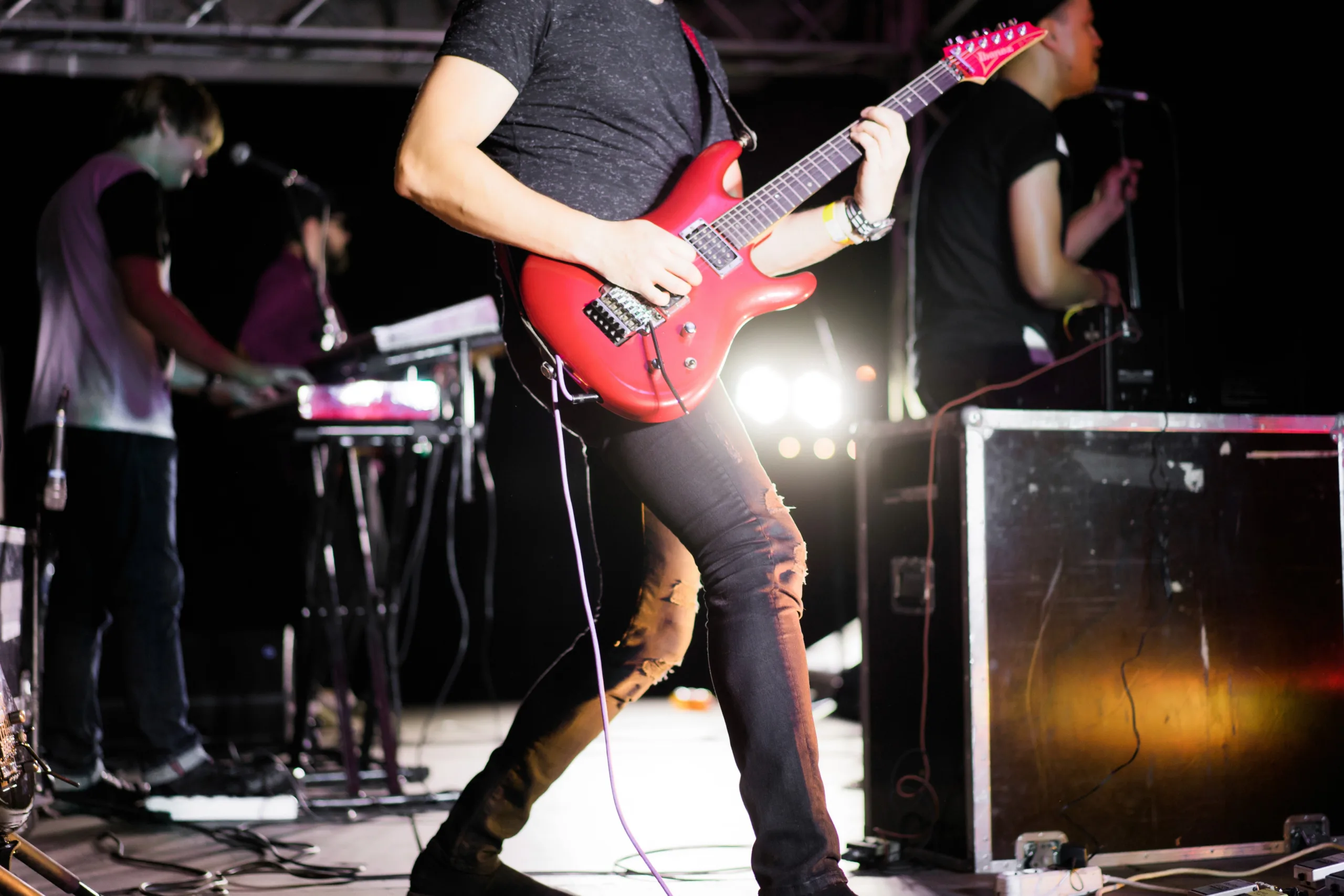 Band performing with electric guitar.