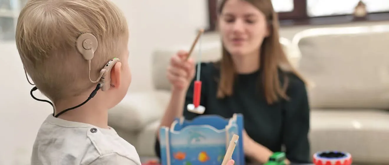 Child with cochlear implant playing.