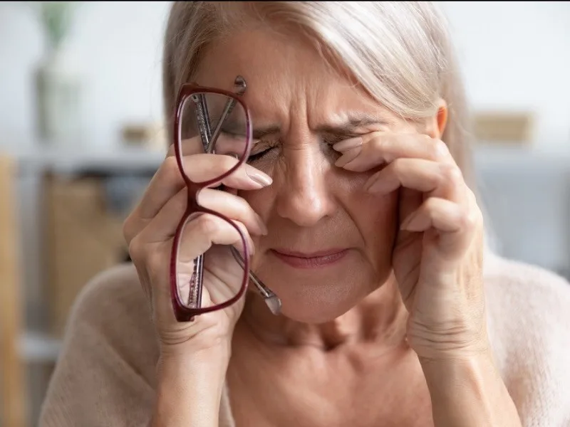 Woman rubbing tired eyes
