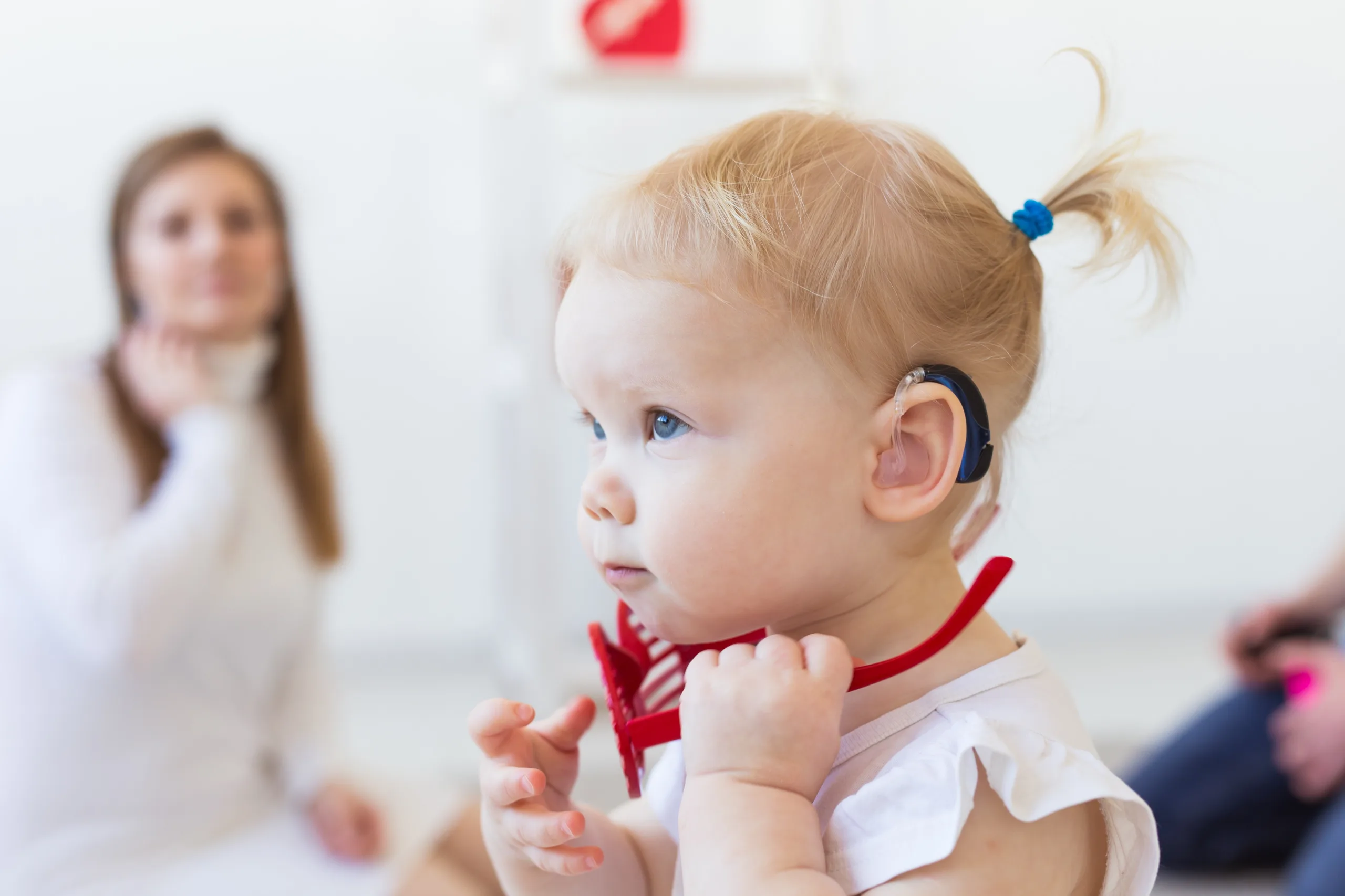 Toddler with hearing aid.