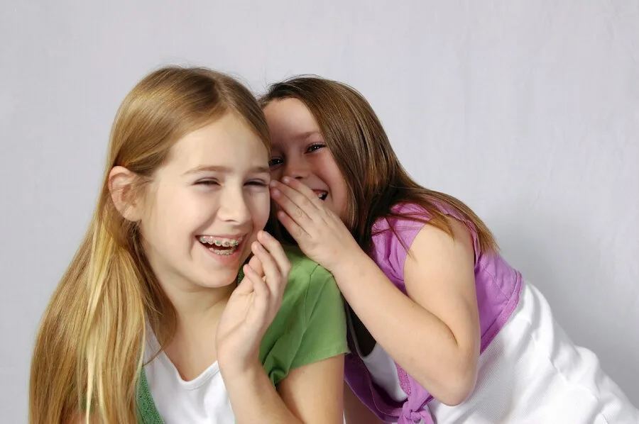 Girls sharing a secret.