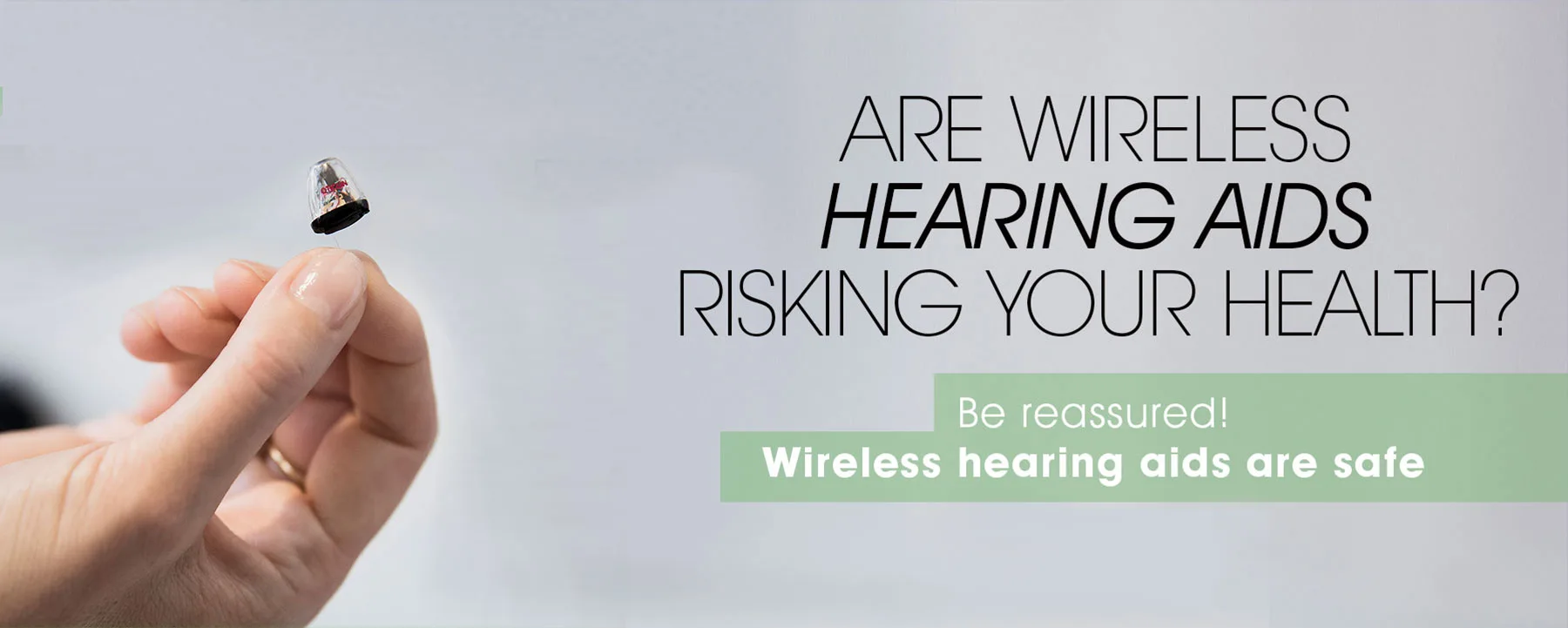 Hand holding a hearing aid.