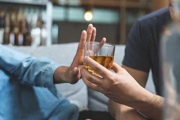 Person refusing a drink.