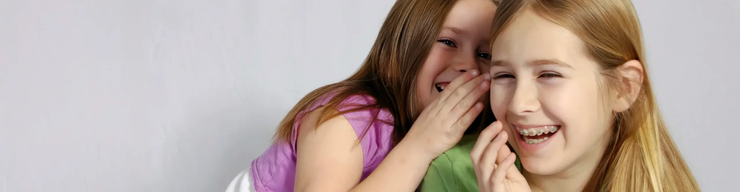 Girls whispering and laughing.