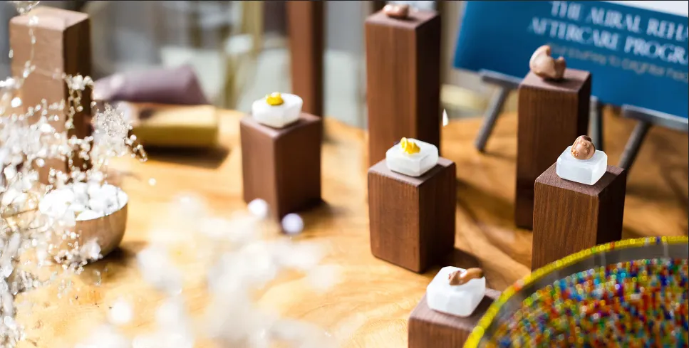 Hearing aids on wooden stands.