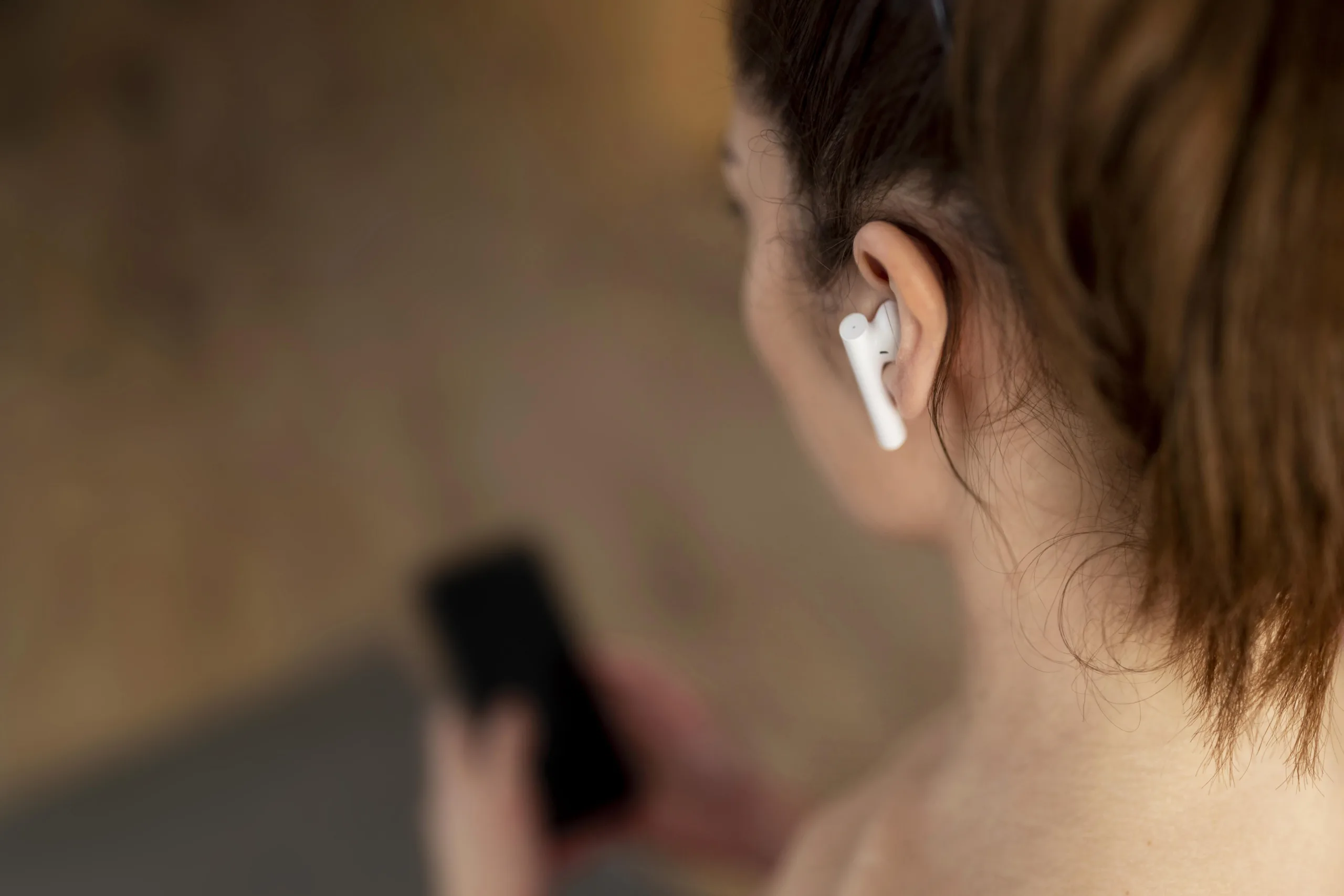 Person with wireless earbud.