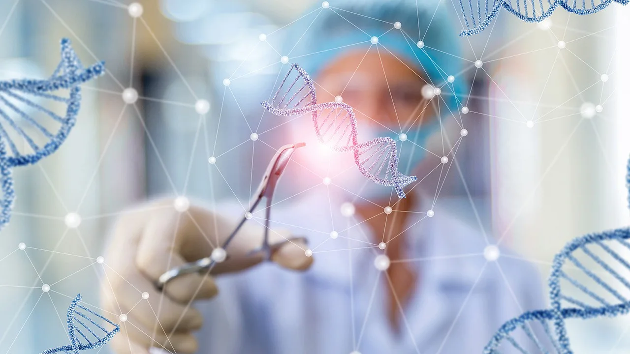 A scientist in protective gear works in a lab with illustrated DNA strands
