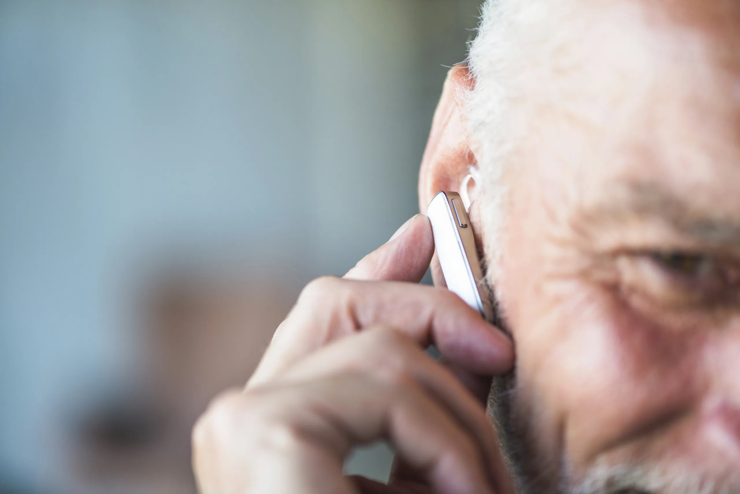 Person using hearing aid device.
