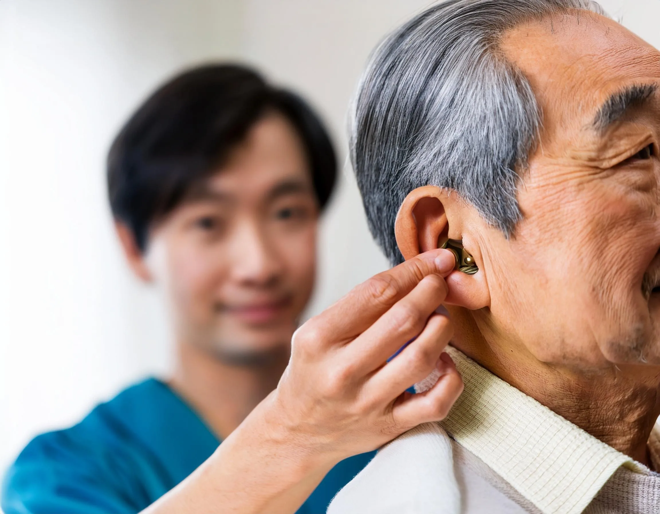 Man fitting hearing aid