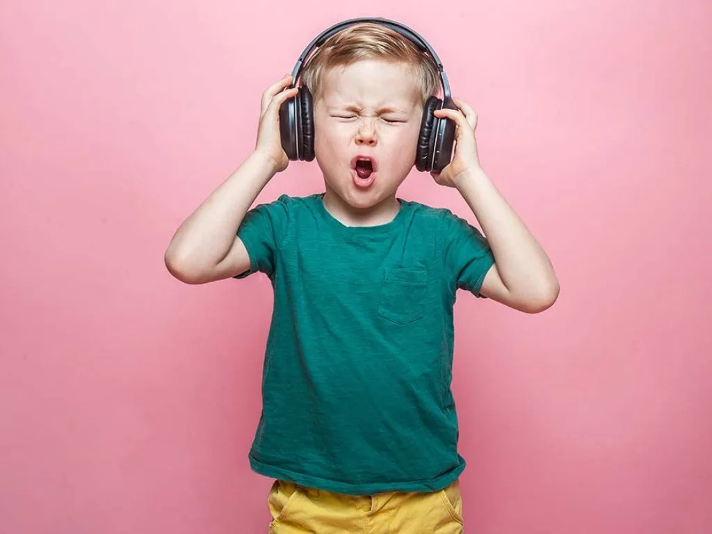 Child singing with headphones