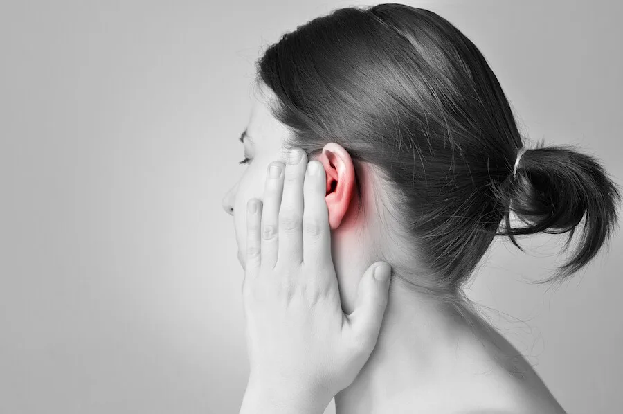 Person with ear discomfort.