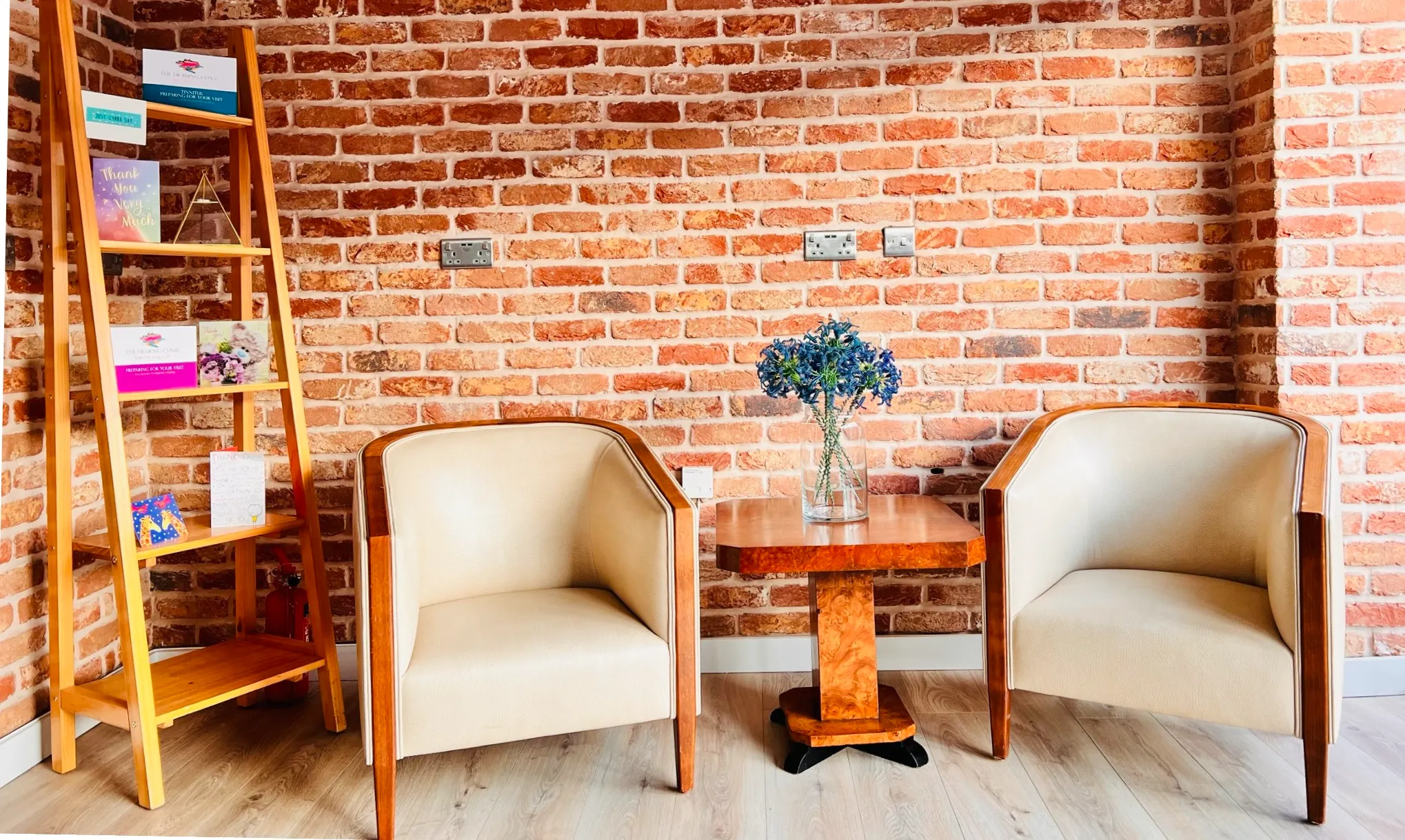 Two chairs, table, flowers.
