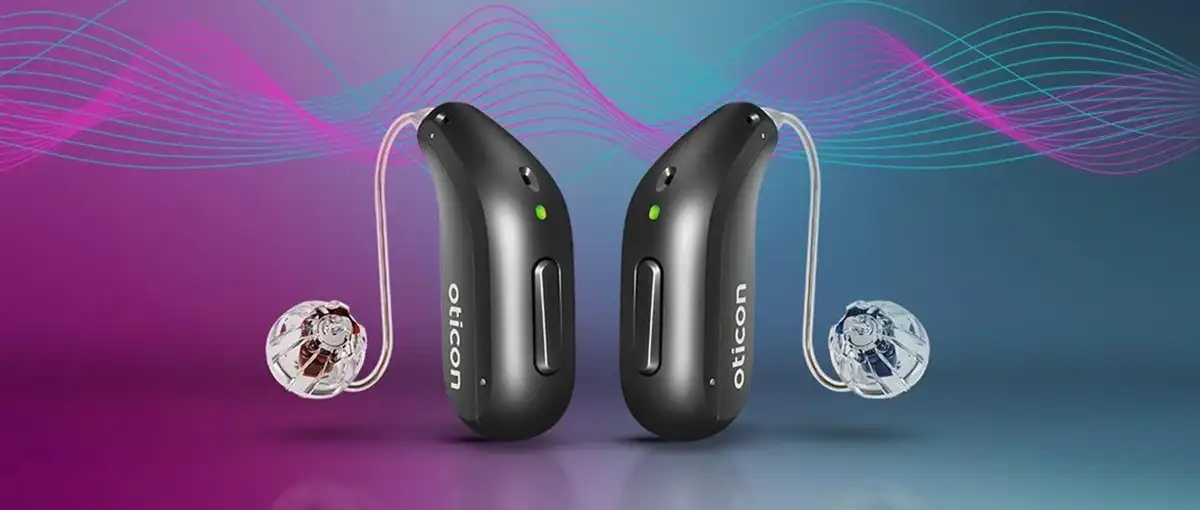 Two black hearing aids displayed